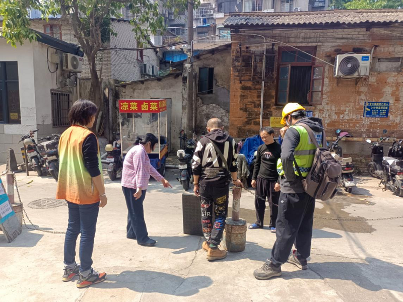 （圖：維修人員與網格員、居民共同商討疏通方案）.png
